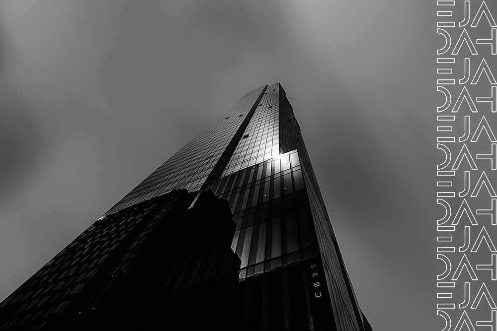 Beautiful low angle shot of a tall skyscraper in black and white